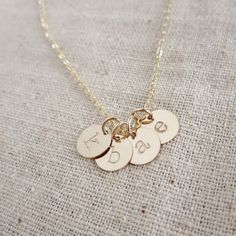 Tiny gold initial necklace mothers necklace by KGarnerDesigns $45 for 5 initials Gold Plated Necklaces With Coin And Initial Pendant, Personalized Initial Pendant Coin Necklace For Gift, Yellow Gold Initial Pendant Coin Necklace Gift, Gold Coin Necklace With Initial Pendant And Adjustable Chain, Dainty Hand-stamped Initial Pendant Charm Necklaces, Grandma Necklace, Gold Initial Necklace, Dainty Initial Necklace, Necklace Mom