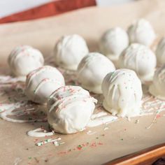 white chocolate covered donuts with sprinkles are on a baking sheet and ready to be eaten