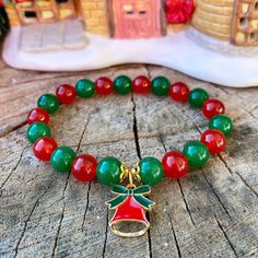 This handmade gemstone bracelet is made from genuine 8mm Green Jade beads and 8mm Red Jade beads, and is strung on a high quality stretch cord. This natural gemstone bracelet is a beautiful gift idea for the Christmas season, as a stocking stuffer, or a gift for yourself.  Please see picture 8 to determine your ideal bracelet length in order for the bracelet to be made to fit nicely around your wrist.  Please note that if you would like the bracelet to fit snug around your wrist then measure with the measuring tape tightly around your wrist. If you prefer a bit of a loose fit then order 1/2 inch bigger (ex: my wrist measures 6 inches tightly, but I prefer a bit of a looser fit so I would order a 6.5 inch bracelet).  Please see picture 7 to determine which Christmas charm you would like on Holiday Bracelets, Crystal Bead Jewelry, Bracelet Inspo, Red Jade, Bracelet Christmas, Christmas Bead, Christmas Bracelet, Christmas Charms, Bracelet Ideas