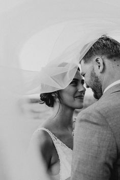 a bride and groom are looking at each other