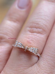 Metal: 14K Rose Gold Weight: 2.5 grams Stone Type: Diamonds Stone Shape: Round Diamond Weight: .32 Carats Size: 7 Sizing: This ring can for sure be sized up to 2 sizes up or down. Beyond that we might need to custom make the ring to your size. It can be made at any size. Please state size in size box, or contact us if needed. Customization: This ring can be custom made with any gems and metals of your choice. Please inquire. Design Element: Bow Matching Necklace: https://www.etsy.com/listing/205 14k Rose Gold Promise Jewelry, 14k Rose Gold Jewelry With Diamond Accents, 14k Rose Gold Round Band With Diamond Accents, Delicate Rose Gold Diamond Ring With Vs Clarity, 14k Rose Gold Jewelry With Diamond Accents Round Cut, Diamond White 14k Rose Gold Jewelry With Vvs Clarity, Rose Gold Jewelry With Pave Setting In Cubic Zirconia, Diamond White Vvs Clarity 14k Rose Gold Jewelry, Rose Gold Cubic Zirconia Jewelry With Pave Setting