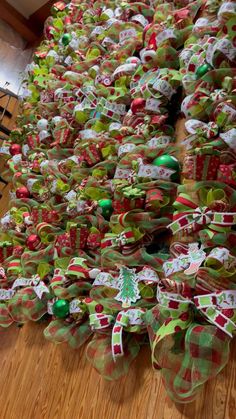 many bows are stacked on top of each other in the shape of christmas tree ornaments