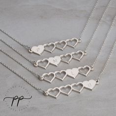 "These four heart initial necklaces make a gorgeous set to share amongst sisters or best friends. The necklaces are designed so that each pendant has one full heart and three cut out hearts, symbolizing the others who share the same necklace set. These jewelry sets help to create and strengthen bonds between friends and sisters. It helps keep people feeling close even when they may geographically be far away from one another. Each pendant can be engraved with any initial of your choice. The engr Best Friend Necklaces For 4 People, Heart Charm Double Heart Jewelry For Best Friend, Double Heart Charm Jewelry For Best Friend, Heart Charm Double Heart Necklace For Best Friend, Double Heart Charm Necklace For Best Friend, Heart-shaped Charms Jewelry For Best Friend Gift, Sterling Silver Initials Jewelry For Best Friend Gift, Silver Name Necklace For Best Friend, Sterling Silver Necklace With Heart Charm For Best Friend