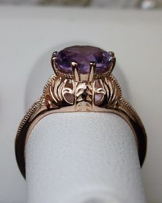 "Natural Amethyst Ring Description Elizabeth Design#158 MADE TO ORDER Here we have a Victorian/Edwardian reproduction ring in sterling silver with rose gold overlay (rose gold \"embraced\") filigree with a natural 1.3ct amethyst gemstone solitaire. This full cut round cut amethyst is 8mm in diameter. This ring also sits 8mm off the finger. The inside of the band is marked 925 for sterling. Notice the beautiful leaf design of the silver and gold filigree setting and etched band. This is a lovely Filigree Ring Gold, Victorian Wedding, Gold Filigree, Filigree Ring, Engraved Items, Size 10 Rings, Amethyst Gemstone, Amethyst Ring, Silver Rose Gold