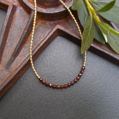 A dainty beaded necklace featuring faceted and polished hessonite garnet stones. I've paired them with tiny gold Czech glass seed beads in two sizes. The necklace is finished with a gold filled spring ring clasp, gold plated extender chain, and one final wire wrapped garnet stone. Coordinating earrings are available in the link below. Necklace length: 15 3/4" plus 2" extender chain Coordinating Earrings https://www.etsy.com/listing/1757148401/dainty-hessonite-garnet-gold-earrings?click_key=15f401c6f0333850de10aeaa6dbec6253ba4a2aa%3A1757148401&click_sum=7db057ea&ref=shop_home_active_11&sts=1 Beaded Necklace Collection: https://www.etsy.com/shop/BonArtsStudio?ref=seller-platform-mcnav&section_id=17053954 See What's New: https://www.etsy.com/shop/BonArtsStudio?ref=seller-platform-mcnav&sectio Red Stone Necklace, Layering Jewelry, Garnet And Gold, Necklace Collection, Hessonite Garnet, Garnet Stone, Bead Chain, Layered Jewelry, Necklace Dainty