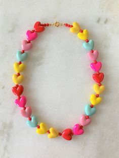 "Kids Brite Multi Colored Plastic Heart Necklace with Red Mini Spacer Beads Gold Tone Spring Ring Clasp Closure Brite Multi Hearts are Red, Hot Pink, Pink, Aqua, Yellow Hearts Measure 5/8\" Wide Necklace Measures 15\" Imported COMPLIMENTARY DOMESTIC SHIPPING" Adjustable Colorful Beads Necklace For Valentine's Day, Heart-shaped Colorful Beads Jewelry For Valentine's Day, Valentine's Day Multicolor Beaded Necklaces, Valentine's Day Heart-shaped Jewelry With Colorful Beads, Valentine's Day Heart-shaped Colorful Beads Jewelry, Colorful Beads Heart Shaped Beaded Necklace Gift, Heart Shaped Colorful Beaded Necklaces For Gifts, Adjustable Beaded Necklaces With Heart Beads For Valentine's Day, Adjustable Beaded Necklaces For Valentine's Day