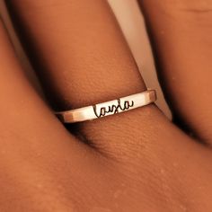 This personalized stacking ring features a unique and stylish handwriting font or serif font, adding a personal touch to your jewelry collection. Handmade with care, each ring is crafted with 14k gold filled or fine silver materials for a luxurious look and feel. Make a statement with this modern and customizable piece. Personalized Meaningful Sterling Silver Rings, Meaningful Personalized Sterling Silver Rings, Dainty Personalized Initial Ring With Round Band, Personalized Dainty Initial Ring, Personalized Gold Engraved Ring For Everyday, Adjustable Stackable Initial Ring, Dainty Personalized Initial Ring, Meaningful Customizable Adjustable Rings, Classic Personalized 14k Gold Midi Rings