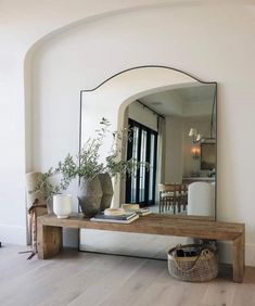 a mirror sitting on top of a wooden table