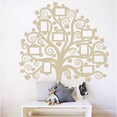 a family tree wall decal with hearts and frames on the top, along with two stuffed animals