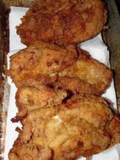 three fried food items sitting on top of a paper towel