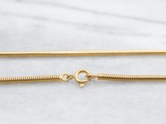 Crafted from yellow gold, this heavy snake chain features a secure spring ring clasp, providing both style and durability. Perfect for any occasion, this timeless piece adds an elegant touch to any outfit!Metal: 18K Yellow GoldWidth: 2.6 mmLength: 32 InchesMarks: "750" Stamped on the clasp Snake Chain, Spring Rings, Timeless Pieces, Yellow Gold, Chain, Ring, Yellow, Gold