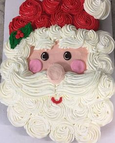 a cake shaped like santa claus with red roses on it's head and nose