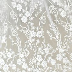 the sheer fabric has white flowers on it