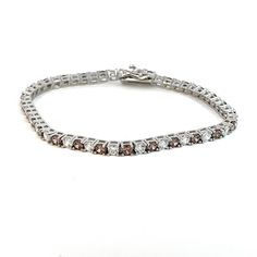 Introducing our stunning Rhodium-Plated Italian-Made Tennis Bracelet, a harmonious fusion of Italian craftsmanship and timeless elegance. Crafted with meticulous attention to detail in Italy, this bracelet is adorned with exquisite white and cognac-coloured stones set in .925 Italian Silver, creating a mesmerizing symphony of colour and brilliance. Each stone is carefully selected for its impeccable clarity and captivating hue, expertly set within the shimmering links of the bracelet. The altern White Jubilee Bracelet Jewelry With Cubic Zirconia, White Cubic Zirconia Jubilee Bracelet, White Jubilee Bracelet With Cubic Zirconia, Elegant Chain Bracelet With Sparkling Stones, Elegant Round Chain Bracelet With Sparkling Stones, Elegant White Tennis Bracelet With Prong Setting, Classic Bracelets With Sparkling Stones In Diamond White, Classic White Sterling Silver Bracelet With Diamond Accents, Elegant White Tennis Bracelet With Diamond Accents