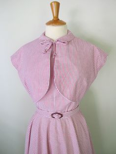 This 1950s style one-piece dress is made out of cotton fabric available in various fabric options! It features a halter bodice with an open back, peter pan collar with a front bow tie, circle skirt, and matching belt.(i use vintage buckles so they may be different from the ones in the pics) . Zips up the back with a hidden zipper a hook and an eye on the top. The bodice is fully lined with cotton lining! Available in all sizes. Pm me before you buy! I will need measurements for bust, waist, and 1950s Halter Top, Classic Summer Dress With Striped Collar, 1950's Dress, Circle Skirt Dress, Vintage 1950s Dresses, 1950s Style, Dress Halter, 50s Vintage, 1950s Dress