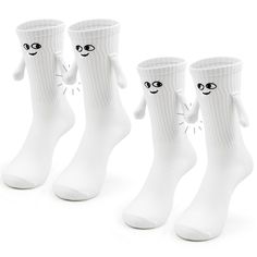 three pairs of white socks with faces on them