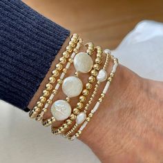 Band (Flat Woven): Horizontal Stripes Band is 1/4"w with 14k gold-filled clasp & 1" extender chain. Strands (Stretch Style): 14K gold-filled 2mm-5mm round beads. Glass seed beads. 10mm freshwater coin pearls. 20x15mm Magnesite oval puff. 5x7mm freshwater rice pearls. More plain gold ball individual bracelets are available here. More seed bead/gold ball individual bracelets are available here. Also available in 14K rose gold fill or sterling silver by email request. Pearl Bracelet With Spacer Beads, Adjustable Stackable Pearl Bracelet, Adjustable Pearl Beaded Bracelets Stackable, Adjustable Stackable Pearl Beaded Bracelets, Stackable Adjustable Pearl Bracelet With Round Beads, Stackable Pearl Bracelets With Round Beads, White Pearl Beaded Bracelets With 8mm Beads, Adjustable Stackable Pearl Bracelet With Round Beads, Hand-strung White Pearl Bracelet With Round Beads