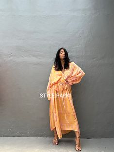 Jimbaran dress  is an oversized long sleeve soft rayon voile Long shirts  dress  .  This Oversized shirt dress is designed to flatter every body type and fit numerous occasions. 👍Included tali - f e a t u r e s - - Relaxed fit - Front pockets Fabric: 100% Soft rayon voile  Style:oversized fit Color:Bali Hand tie dyed peach & multi motif Wash :Hand cool wash  - measurement -  - One size  -  I recommend American size M to XL Chest /164cm/ 64inch(round) Length/135cm/53inch Transparent - it's  tran Summer Long Sleeve Tunic For Brunch, Flowy Long Sleeve Dresses For Beach Cover-up, Oversized Long Sleeve Tunic For Beach Cover-up, Orange Long Sleeve Maxi Dress For Summer, Oversized Long Sleeve Maxi Dress For Vacation, Orange Long Sleeve Maxi Dress For Vacation, Long Sleeve Summer Maxi Dress For Daywear, Flowy Long Sleeve Beach Cover-up Dress, Orange Long Sleeve Summer Maxi Dress