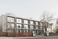 a large building with many windows on the side of it's face and trees in front of it