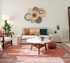 a living room filled with furniture and lots of plants on the wall above it's coffee table