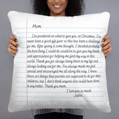 a woman holding a pillow with a poem on it