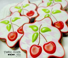 decorated cookies with cherries and leaves on them