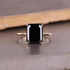 a black diamond ring sitting on top of a table