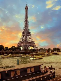 the eiffel tower towering over the city of paris, france as seen from across the river