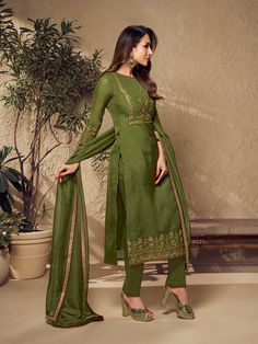 Defined by Malaika Arora's sense of fashion, this mehndi green kurta set is an epitome of grandeur and majestic artwork. Crafted using Zari work and mukaish embroidery, it features a straight top with three-quarter sleeves, a round neck and organza & shantu inner for comfort. The set includes a pair of cotton trousers and an organza dupatta with exquisite floral Zari machine weave yoke/border embroidery and taping. TOP: Organza, TOP INNER: Shantun, BOTTOM: Cotton, DUPATTA: Organza, Dry Clean Elegant Chanderi Churidar With Floral Embroidery, Elegant Churidar With Floral Embroidery In Chanderi, Wedding Art Silk Kurta With Floral Embroidery, Diwali Dola Silk Kurta With Floral Embroidery, Designer Pista Green Churidar With Floral Embroidery, Floral Embroidered Dola Silk Churidar For Designer Wear, Festive Dola Silk Kurta With Floral Embroidery, Diwali Tissue Silk Churidar With Straight Kurta, Straight Kurta Churidar With Zari Work In Tissue Silk