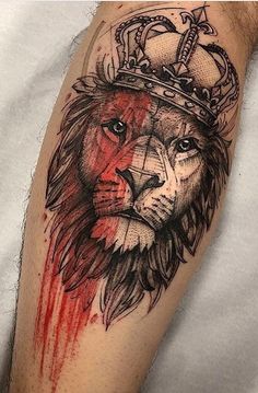 a lion with a crown tattoo on his arm