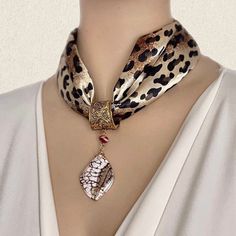 A square  leopard skin scarf in black/ brown shads with a beautiful natural stone scarf pendant.   The base of the pendant is made of a decorated bronze spring opening & closing system. The jewelry crafted with one polished slide of Zebradorite stone with a creamy white base . Impressive, feminine and adds classic style luxury to any look. A multi-purpose gift for a woman you love. The pieces can be worn separately with another scarf or on a choker neckline top Size of the scarf:18 1/2inches x 1 Diy Scarf, Scarf Necklace, Leopard Skin, Scarf Rings, Luxury Scarves, How To Wear Scarves, Scarf Jewelry, Pretty Gift, Beaded Jewelry Diy