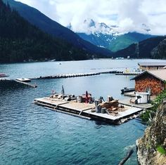 the dock is surrounded by mountains and water