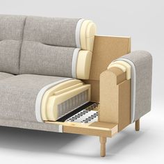 a couch that is sitting on top of a wooden table with a drawer underneath it