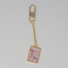 This minimalist and stylish purse charm is the perfect addition to your everyday carry planner! Featuring a chic design of floating shimmering circles in shades of red and pink in a gold rectangular bezel pendant, that hangs from a gold chain with a gold clasp. Perfect for any occasion or as a gift to a loved one, this planner/purse charm is sure to be a treasured favorite. Bougie Girl, Chic Purses, Stylish Purse, Bezel Pendant, Girls Boutique, Purse Charms, Everyday Carry, Shades Of Red, Chic Design