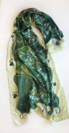 Green Silk Scarf hand painted. Mothers Day gift. Woman fashion wrap in green and aqua colours combo. Handpainted scarves. Art Deco shawl painted. Long Luxurious shawls. Unique handmade scarves. Silk painting, Evening shawl wrap. Garden Wedding accessory. Wedding accessory. Romantic wedding style. Botanical scarf. Olive green silk scarf with turquoise flowers painted in stylized composition. ♥This is a unique, hand painted silk scarf measuring 35 by 70 inches. Silk scarf painted on pure silk 6mm, Handmade Green Bohemian Silk Scarf, Handmade Bohemian Green Silk Scarf, Green Bohemian Silk Shawl, Traditional Handmade Green Shawl, Green Scarf As Spring Gift, Green Scarves For Spring Gift, Elegant Handmade Green Silk Scarf, Green Scarf For Spring Gift, Green Bohemian Dupatta Scarf