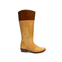 Vintage 1970s women's tan leather knee high western style riding boots. Features tan leather uppers with brown leather band at top of shaft, rounded toe, pull on style with no closures, rounded tops, and short wooden block heel. Very good vintage condition with wear at sides and toe. No branding stamp.   Heel to toe (inside shoe): 9.375 inches  Ball of foot (bottom of sole): 3.25 inches  Heel height: 1.5 inches  Shaft height: 13.5 inches  Circumference: 14 inches  Size 7 Wide Calf Leather Knee-high Boots For Ranch, Western Brown Leather Knee-high Boots, Western Style Brown Leather Knee-high Boots, Vintage Mid-calf Leather Boots, Brown Knee-high Boots For Ranch In Fall, Fitted Brown Knee-high Boots For Ranch, Vintage Leather Knee-high Boots With Round Toe, Vintage Brown Vegetable-tanned Boots, Western Leather Knee-high Boots Medium Width