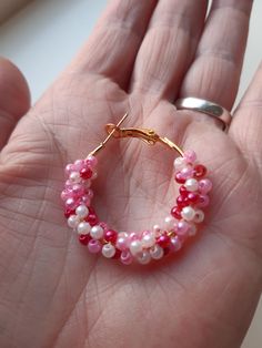 Gouden hoop earrings with 3 color pink small beads. I made the beads around the circle of the earring. The hoop earrings are of stainless steel, retain the color, and have a locked closure. The beads are 0,08 inches round long and the have the color, light pink, pink and dark pink. The earrings are of stainless steel and 1,18 inches round. These hoop earrings are light and comfortable to wear. These earrings are made with love. Beautiful summer earrings, the match any type of clothing. The jewel Handmade Pink Hoop Earrings Gift, Pink Hoop Beaded Earrings With Tiny Beads, Pink Tiny Beads Hoop Earrings, Handmade Pink Hoop Earrings, Pink Hoop Earrings With Tiny Beads For Gift, Pink Hoop Earrings With Tiny Beads As Gift, Pink Small Hoop Beaded Earrings As Gift, Pink Small Hoop Earrings For Gift, Handmade Pink Hoop Jewelry