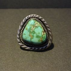 "VINTAGE NAVAJO RING DESCRIPTION: With an extra lovely specimen of natural Royston turquoise, this ring will be a treasured addition to your collection of fine vintage Native American jewelry. MEASUREMENTS: Ring face measures 1 5/8\" x 1 1/2\" Cabochon measures 25mm x 23mm RING SIZE: 11 WEIGHT: 28.4 grams SIGNED: bh (Navajo) STERLING: unmarked, verified sterling silver" Vintage Sterling Silver Turquoise Ring With Large Stone, Southwestern Style Green Turquoise Collectible Ring, Southwestern Style Collectible Turquoise Ring, Vintage Rings With Large Stone For Collectors, Vintage Rings With Large Stone For Collectible, Vintage Collectible Rings With Large Stone, Western Green Turquoise Ring In Sterling Silver, Western-style Turquoise Ring With Patina, Southwestern Green Ring With Large Stone