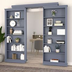 an open bookcase with books on it in a living room next to a desk