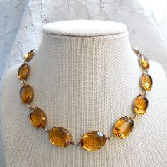 "Georgian era women would approve of this beautiful handmade statement necklace, featuring luxurious vintage citrine colored crystal rhinestones and your choice of settings finish in gold, silver or antiqued brass! The length is adjustable from 15 1/2\" to 17 1/2\" thanks to the two inch extender. Each stone is a nice size oval of 18x13mm. Noticeable, classic, not too flashy, but honey it WILL grab attention. Mix it up with more shapes and sizes! Sparkle on! AND as always, Your Sacred Cake purch The September Issue, Handmade Statement Necklace, Handmade Crystal Necklace, Blue Statement Necklace, Rhinestone Statement Necklace, Layered Chokers, Citrine Necklace, Butterfly Pendant Necklace, Anna Wintour