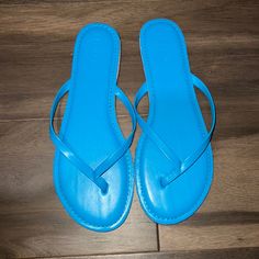 Never Worn. Blue Slip-on Summer Flip Flops, Light Blue Synthetic Flat Flip Flops, Blue Slip-on Flip Flops For Beach Season, Light Blue Sandals With Round Toe For Beach, Light Blue Round Toe Sandals For Beach, Casual Blue Flip Flops For Summer, Casual Blue Sandals For Summer, Light Blue Flat Flip Flops For Summer, Blue Flat Sandals For Summer