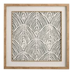 a white and wood frame with an intricate pattern on the wall in front of it