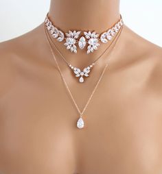 Amazing Stemenet rose gold layered necklace created with large stones for a dramatic style. Created with Swarovski Pure Brilliance stones for stunning sparkle like real diamonds. Avaialbe in 3 finished, rose gold, rhodium or yellow gold finish. Necklace choker part measures 13 inches in photos. Extends to 15 inches. Longest part measures 19 inches. Matching bracelet: https://www.etsy.com/listing/475583792/rose-gold-bracelet-bridal-bracelet?ref=shop_home_feat_4 Suggested earrings: https://www.ets Rose Gold Layered Necklace, Rose Gold Choker Necklace, Kalung Choker, Rose Gold Choker, Gold Layered Necklace, Necklace Bridal, Gold Necklace Layered, Fantasy Jewelry, Diy Schmuck