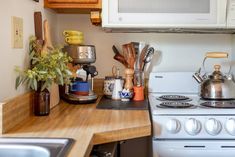 the kitchen counter is covered with pots, pans and other cooking utensils