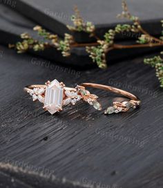 an image of a ring with stones on the side and flowers in the back ground