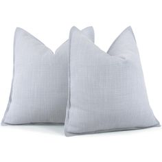 two gray pillows sitting next to each other