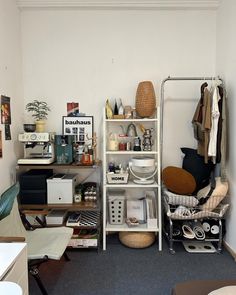 a room filled with lots of clutter next to a wall mounted shelf and chair