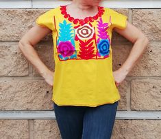 Well designed and well embroidery only for you!! Beautiful blouse with beautiful colorful flowers and short sleeve. Made in Chiapas, Mexico creating fashion and art. Very comfortable, Goes great with jeans, leggings, skirt, shorts... Each piece is unique and handmade with dedication and taking care of every detail achieving the best quality in our products, which is why it makes it beautiful and unique each of the embroidered flowers. COLOR IN YELLOW, GREEN, BLUE OR BLACK This blouse is one size Handmade Blouse, Mexican Women, Flowers Color, Boho Handmade, Comfort Shoes Women, Skirt Shorts, Women Blouse, Jeans Leggings, Mexican Style