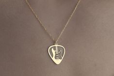 Custom Electric Guitar Necklace 925 Sterling Silver, Guitar Jewelry, Musician Necklace, Guitarist Gift, Personalized Jewelry, Rock Guitar TO OUR VALUED CUSTOMERS ! Please take a look at our special catalog that we have prepared for you ! ▶ https://www.etsy.com/shop/MarryMinimalist ✔️ All products in our unique store are personalized. ( You can find our font list in the images ) D E T A I L S ✔️A lifetime silver CLEANING CLOTH is given as a GIFT along with the 925 Sterling Silver Necklace! ✔️ * Made to Order. * Handmade with Sterling %100 925K Sterling Solid Silver. * Choice of Gold Color: Gold, Rose Gold, Silver * Length: 14", 16", 18", 20", 22" * Ready to Ship in 1-3 Business Days * Free returns within 14 days from the order date. ✔️ 24/7 Friendly Customer Service, contact us for any ques Guitar Necklace, Guitar Jewelry, Silver Guitar, Guitarist Gifts, Silver Cleaning, Custom Electric Guitars, Rock Guitar, Love Gifts, Cleaning Cloth