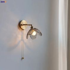 a white wall with a light that is on it's side next to a window